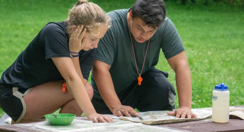 Two people examine a map
